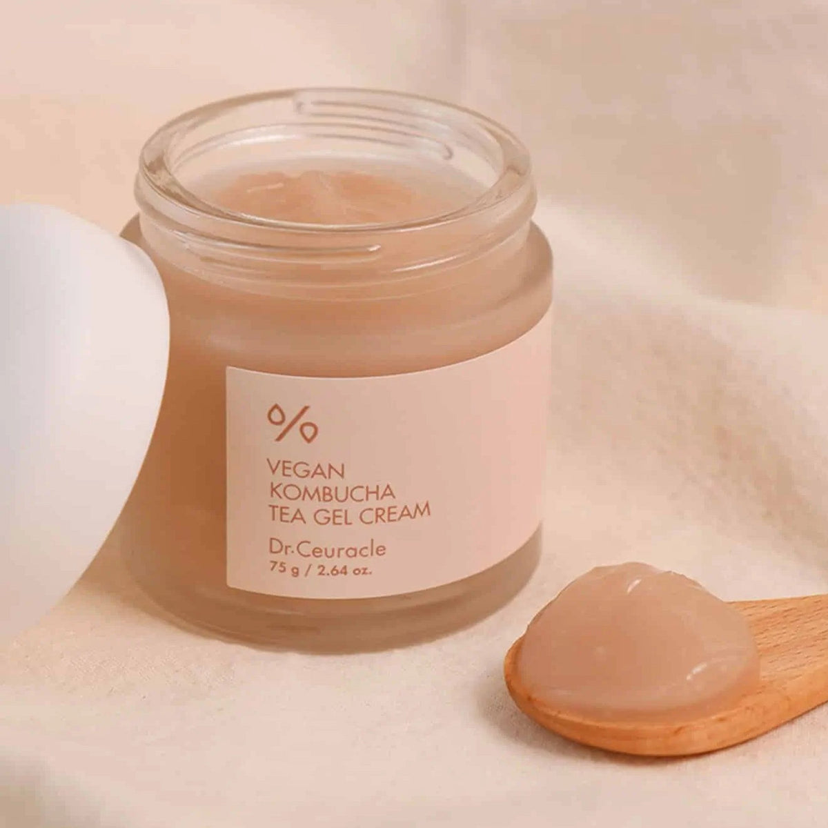 Dr. Ceuracle vegan kombucha tea gel cream jar with translucent pale peach gel scoop