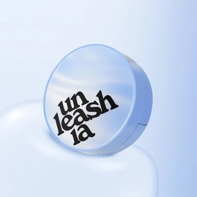 Light blue cushion compact with round lid featuring the “unleashia” logo
