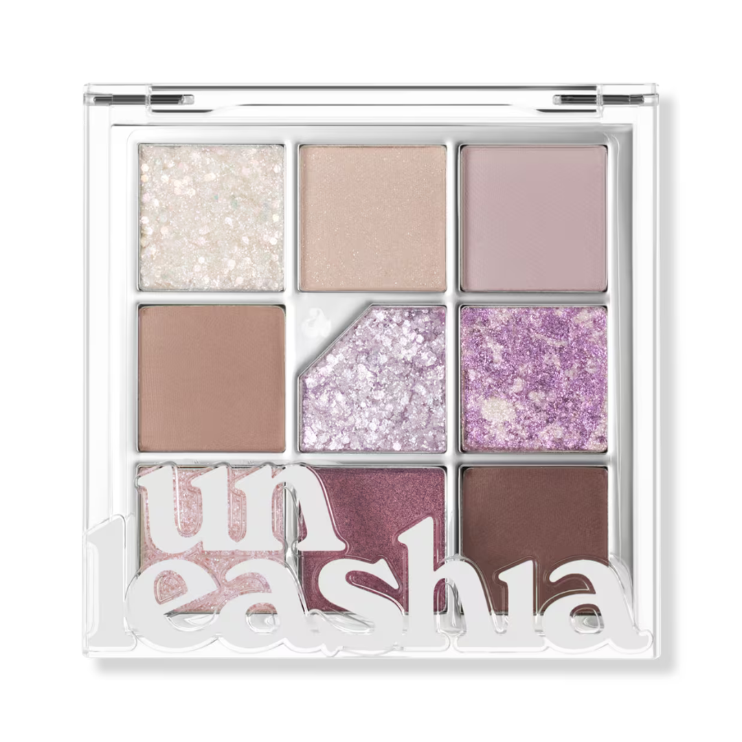 Nine-pan glitter eye palette with pale nude, mauve, lavender, lilac, and deep purple shades