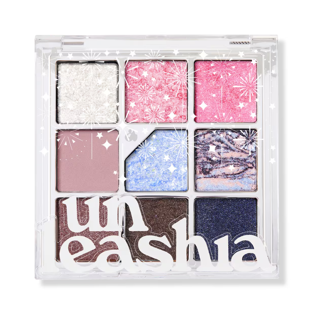 Eyeshadow palette with cool glitter shades: white, blue, pink, and lavender in clear compact