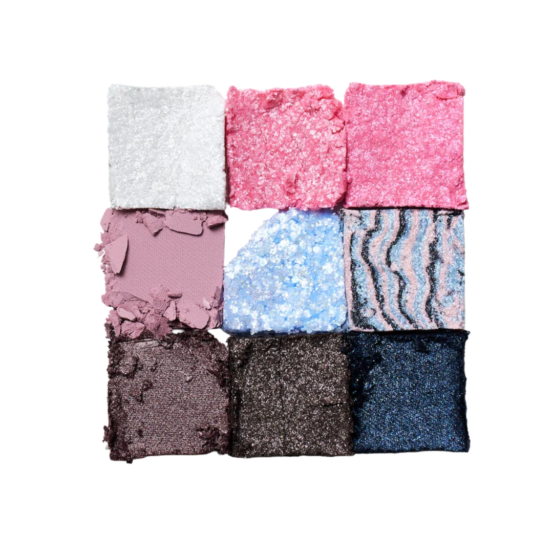 Eyeshadow palette pan set with dark and cool shades: gray, plum, blue, black, and navy glitter