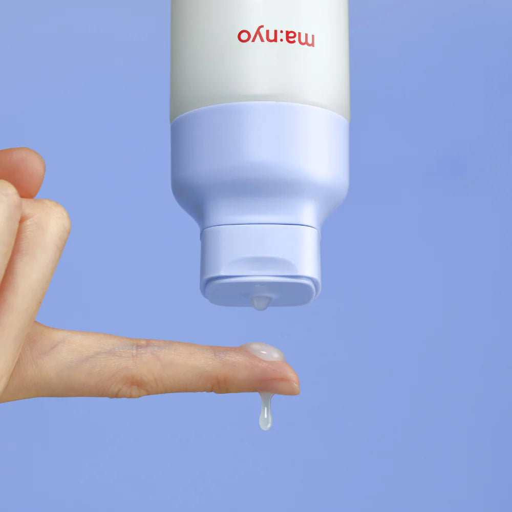 Toner essence bottle close-up with a single droplet dispensing