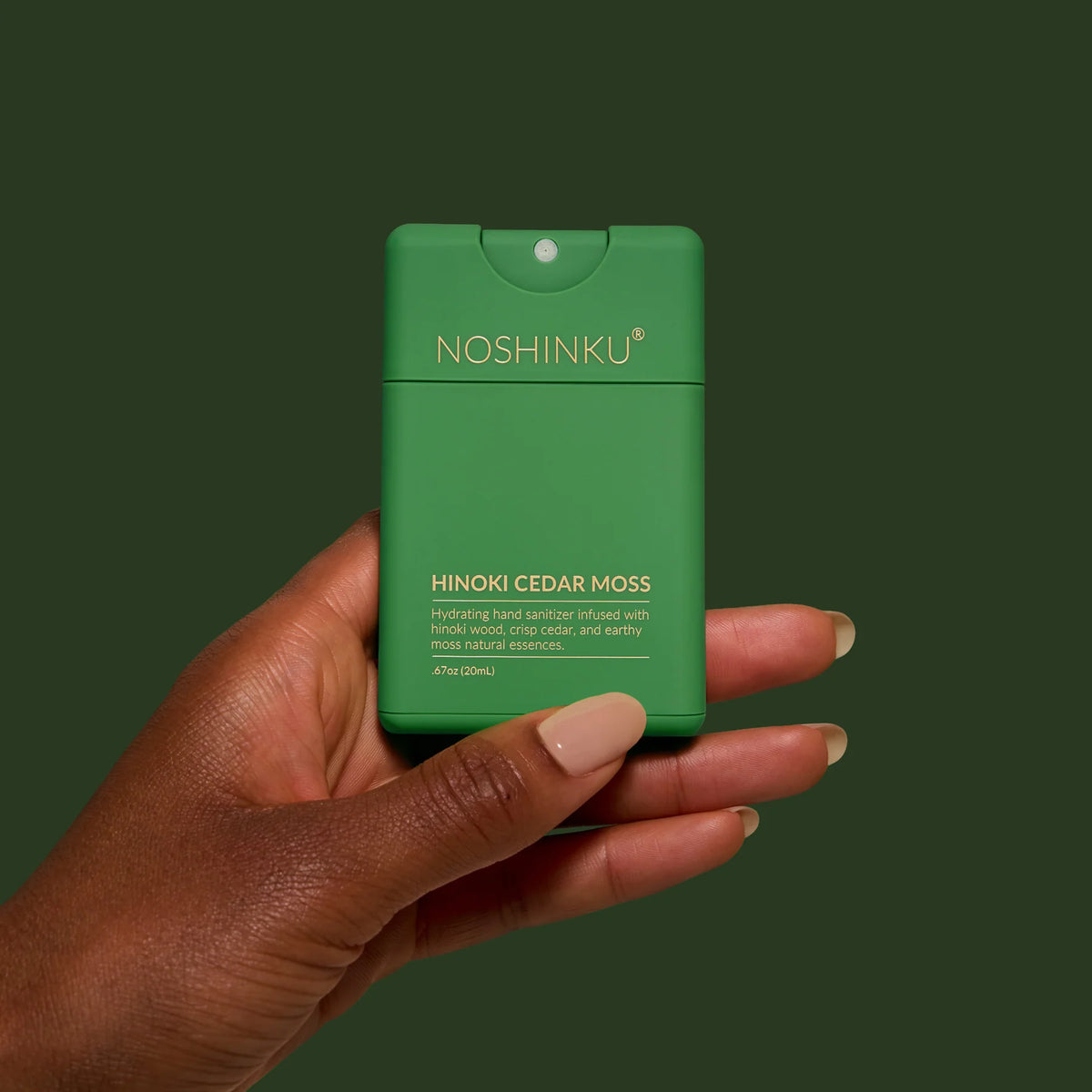 a hand holding a green container