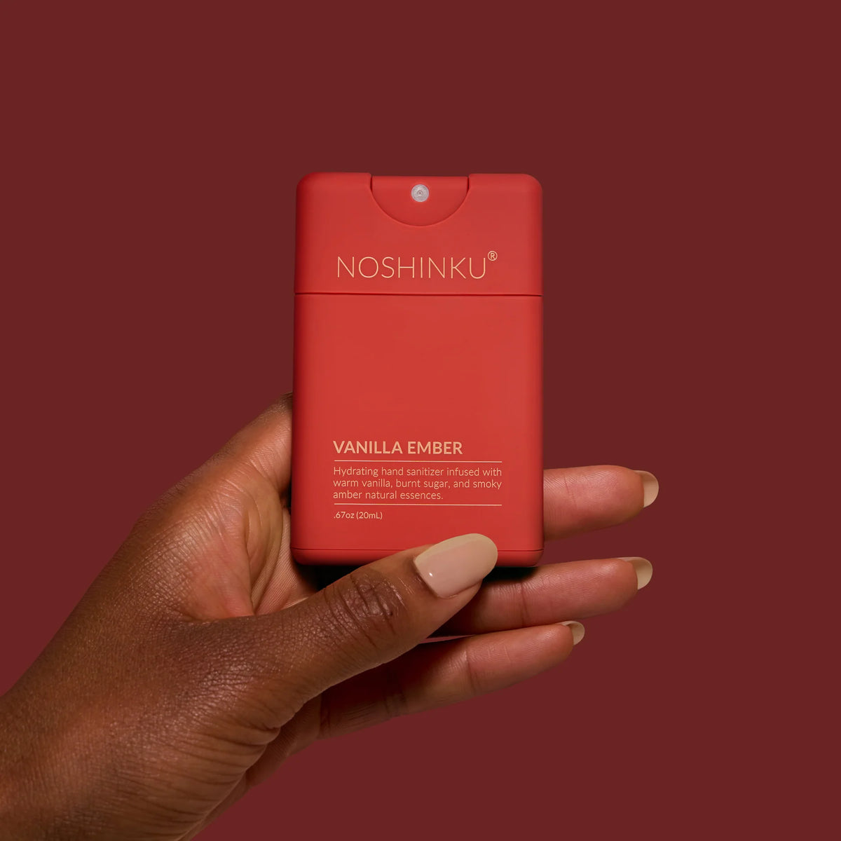 a hand holding a red container