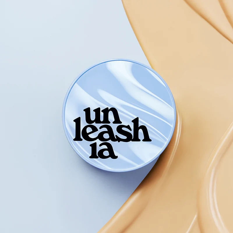 Blue cushion foundation compact with UNLEASHIA logo on skin