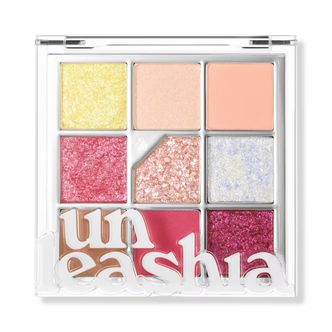 Eyeshadow palette with glitter pans: yellow, pink, peach, lavender, and magenta in clear case