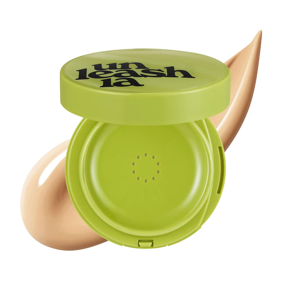 Green round cushion compact with open lid and puff, showing embossed dot pattern
