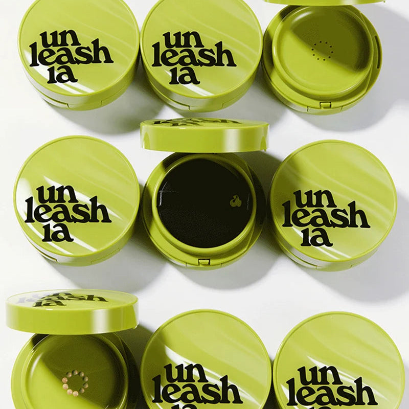 Assorted green cushion compact cases with open lids and embossed branding